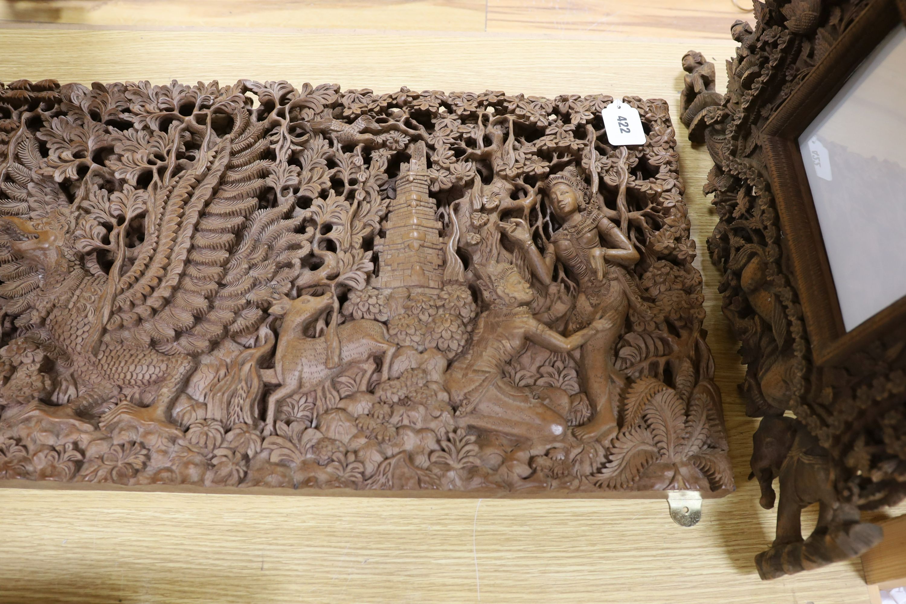 A Burmese or Indonesian graduated carved wall hanging what not, similar frame and carved panel